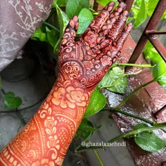 Another look at the developed henna stain, showing the depth of color against a natural green background.