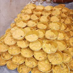 Gajar ka Halwa (carrot halwa) portioned into individual cups, ready to be served at an event.