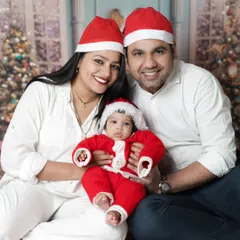 Christmas is for family. We love when parents join in for our festive mini-sessions. This beautiful family portrait captures the joy of their baby's first Christmas.