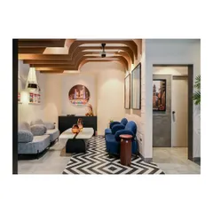 Another view of the reception area, showcasing the interplay of patterns, colors, and the sculptural ceiling fins that define the office's unique design language.