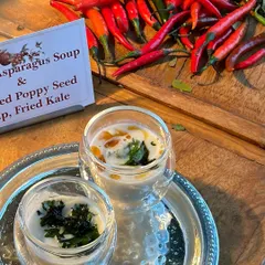 A flavourful explosion on a plate. This flatlay showcases the fresh, vibrant ingredients like red chilies that go into our White Asparagus and Roasted Poppy Seed Soup.