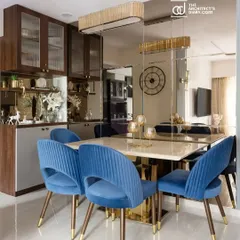 A feature on the dining room of 'The Adobe' project, highlighting the custom blue velvet chairs and the mirror-clad wall that enhances the sense of space and luxury.