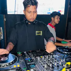 In the zone, concentrating on the turntables. You can see my VDJ screen in the background, which is an integral part of my performance.