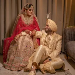 An intimate and heartfelt portrait of a Punjabi couple after their wedding. The soft lighting and their loving gaze create a warm and timeless image that speaks of deep affection.