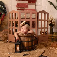 Another pose from our boho bucket setup, this time with a small lantern prop to add a warm, cozy light to the scene.