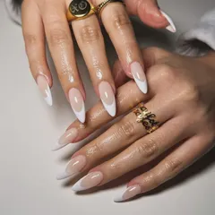 A classic French manicure on beautifully shaped almond nail extensions. This look is elegant, timeless, and perfect for any occasion.