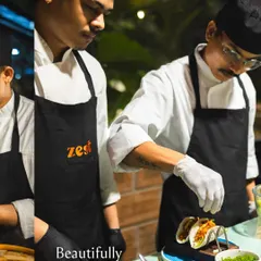 A chef carefully assembles fresh tacos at a live station, ensuring every component is perfect.