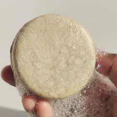 A close up of the lather from our Moringa shampoo bar, shared by a happy customer. They note that it effectively rebalances scalp moisture and leaves hair soft and flake free from the very first wash.