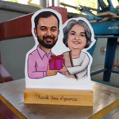 My caricature cut-outs are one of my most popular gifts. I turn a digital drawing into a physical statue with a custom message on a wooden base, perfect for farewells or as a thank you gift.