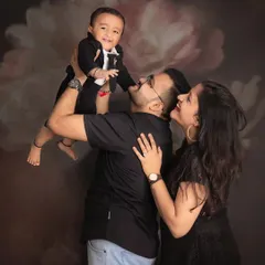 Twinkle, twinkle, little star. This candid family photo captures a sweet, playful moment between parents and their little boy, full of adoration and joy.