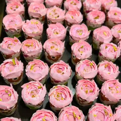 A tray of my Rose Rasmalai cupcakes ready for a party. The beautiful rose piping and pistachio garnish make them as beautiful as they are delicious.
