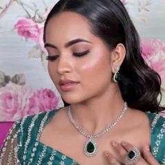 This elegant CZ necklace with a large emerald drop is a statement piece. It's perfect for adding a touch of colour and sophistication to any modern outfit.