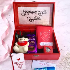 A little red box filled with hugs and sweet surprises. This hamper includes a personalized message on the lid, a teddy bear, Dairy Milk Silk, and other thoughtful love notes.