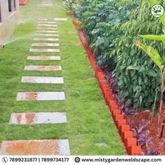 A backyard is a canvas for creating a green sanctuary. For this home in Bommenahalli, we installed a lush natural lawn, laid elegant stepping stones to create a clean pathway, and designed a multi-layered plantation that adds depth and vibrancy to the entire space.