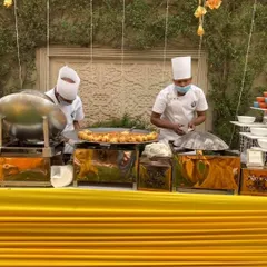 A live tawa station at a Haldi ceremony. My chefs are preparing hot and fresh appetizers for guests, adding an element of theatre to the dining experience.