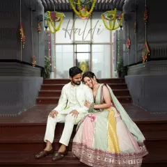 A sweet portrait of the couple during their Haldi ceremony. The bride rests her head on the groom's shoulder, a quiet moment amidst the festivities.