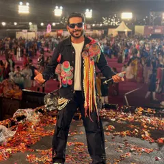 This is me in my element. On stage, mic in hand, with the energy of thousands of people celebrating at a Navratri festival. The confetti, the lights, the roar of the crowd, this is the electrifying atmosphere I live to create.
