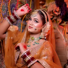 A playful and traditional pose, with the bride's hand raised in a graceful mudra.