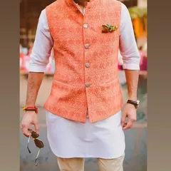 A great example of a modern ethnic look. I tailored this peach-colored Nehru jacket with a subtle woven pattern to be worn over a simple white kurta for a fresh, stylish outfit.
