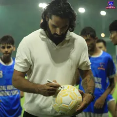 Sandesh Jhingan signing a football for our young, aspiring players during his visit.