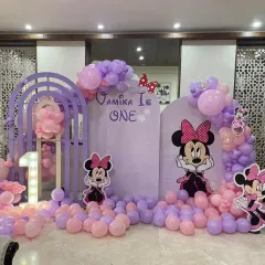 A dreamy Minnie Mouse theme for Vamika's first birthday. I used a pastel purple and pink color scheme with arched backdrops, character cutouts, and a light-up number one.