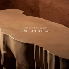 This is our Rokku Bar Table, carved to look like flowing rock. The organic folds, deep shadows, and earthy tone add a dramatic, artistic edge to any bar space without saying a word.