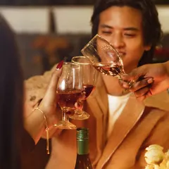 A toast to good times. This close-up shot captures the clinking of glasses, a symbol of the connection and celebration that happens at our intimate gatherings.