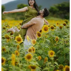 Your love story should be full of joy and spontaneity. We capture these playful, unscripted moments during pre-wedding shoots, like this one in a vibrant sunflower field, creating memories that are as fun as they are beautiful.
