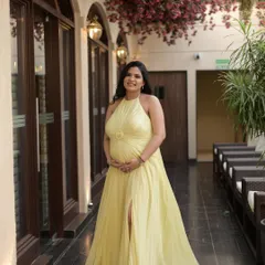 A full-length shot of this glowing mommy-to-be. The makeup is soft and subtle, with a focus on a peachy blush, soft brown eyes, and lots of highlighter to enhance her charm.