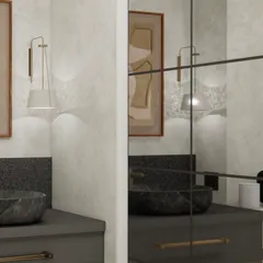 A close-up of the art and wall sconce, showing how the reflection in the large mirror creates layers and depth. This simple shift in layout transforms the entire feel of the space.