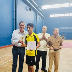 Presenting the trophy to Zehn Masani for one of his six victories at the FOZAWAC tournament. A proud moment for both student and coach.