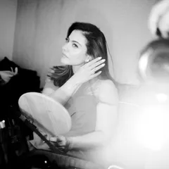 Another artistic, grainy shot from the dressing room, capturing a moment of reflection in the mirror.