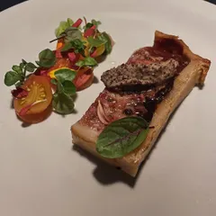 A slice of Pork and Duck Pâté served with a bright tomato gastrique. A classic French starter that showcases deep, developed flavors.