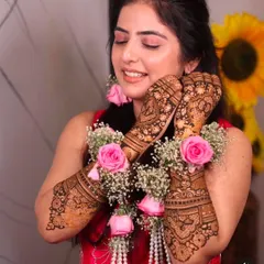A beautiful shot of a bride with floral jewelry that perfectly complements her fresh henna. It's always a joy to see my work as part of the complete bridal ensemble.