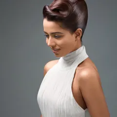 A finished image from a commercial beauty campaign. The final retouching is clean and polished, with a focus on creating luminous skin and perfectly sculpted hair while ensuring the result looks completely natural.