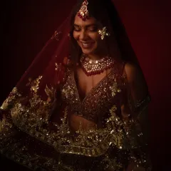 A stunning final shot from a bridal portrait session. The deep red backdrop and our professional lighting create a rich, timeless feel perfect for wedding portfolios.