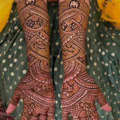 This is a very dense, full-coverage design where the main highlight is the flow of the patterns. You can see a small, auspicious elephant motif at the top of each arm.