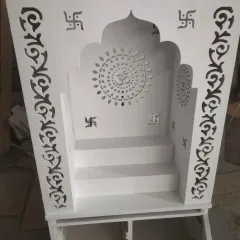 A beautiful mandir design for the home, crafted with CNC-cut jaali work featuring 'Om' and 'Swastik' symbols. The entire unit is finished in clean, white deco paint.