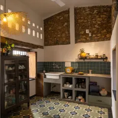 The pantry in our studio. We kept the exposed stone walls and paired them with a custom concrete countertop and beautiful handmade floor tiles. The space is rustic, functional, and full of the building's original character.