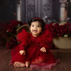 A vision in red. This dramatic floral-themed session uses a rich color palette and beautiful textures to create a stunning and artistic baby portrait.