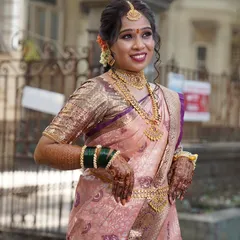 This Maharashtrian bride wanted a classic South Indian look for her wedding. I draped her in this lovely peach and purple Kanjivaram saree, complete with traditional temple jewelry, to create an authentic and beautiful bridal style.