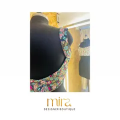 The back design of a custom floral sequin blouse. The deep U-shape and colorful embroidery make it a stunning choice for a sangeet or cocktail event, designed to look beautiful from every angle.