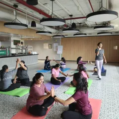 A moment of connection and fun during a partner yoga session, fostering teamwork and positive interaction.