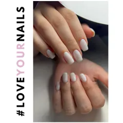 This showcases a beautiful set of gel extensions with a milky white polish. The squared-oval shape gives it a modern yet classic feel that complements any style.