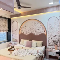This bedroom is a perfect example of a soft, romantic aesthetic. We used a blush pink palette, a custom arched headboard with delicate floral wallpaper, and warm ambient lighting to create a peaceful and visually stunning personal retreat.