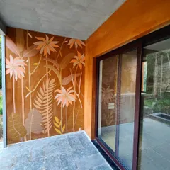 The mural as seen from the side, with its reflection captured in the glass doors.