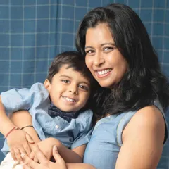 The special bond between a mother and her son shines in this close-up portrait. Her gentle hold and their shared smiles create a heartwarming image that feels both posed and perfectly natural.