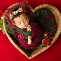 Here, I swapped the headband for a beautiful floral crown with red berries to match the festive theme. Small changes in accessories can create a lovely variety in your final gallery of newborn pictures.