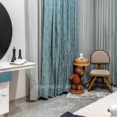 A detail shot of the playful yet elegant corner in the kid's room. The space features a whimsical bear-shaped side table and a stylish chair, perfectly complementing the room's creative and modern aesthetic.