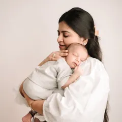 The peaceful, quiet love between a mother and her newborn. My newborn sessions are all about capturing this serene connection in a simple, timeless way.